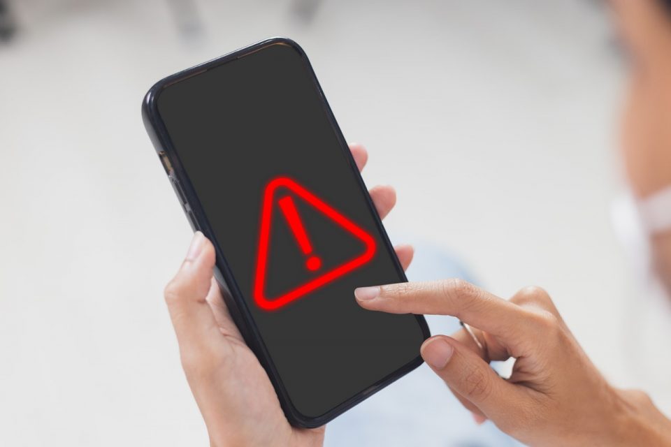 woman-using-smartphone-with-notification-error-warning-sign-mobile-phone-maintenance-connection-application-programmer-developer-security-network-dangerous-960x640