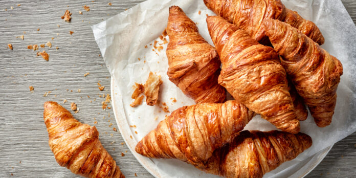 Freshly,Baked,Croissants,On,Grey,Wooden,Table,,Top,View