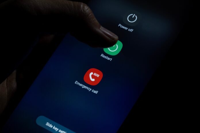 Man,Finger,Clicks,On,Restart,On,Samsung,Android,Phone,,Phone